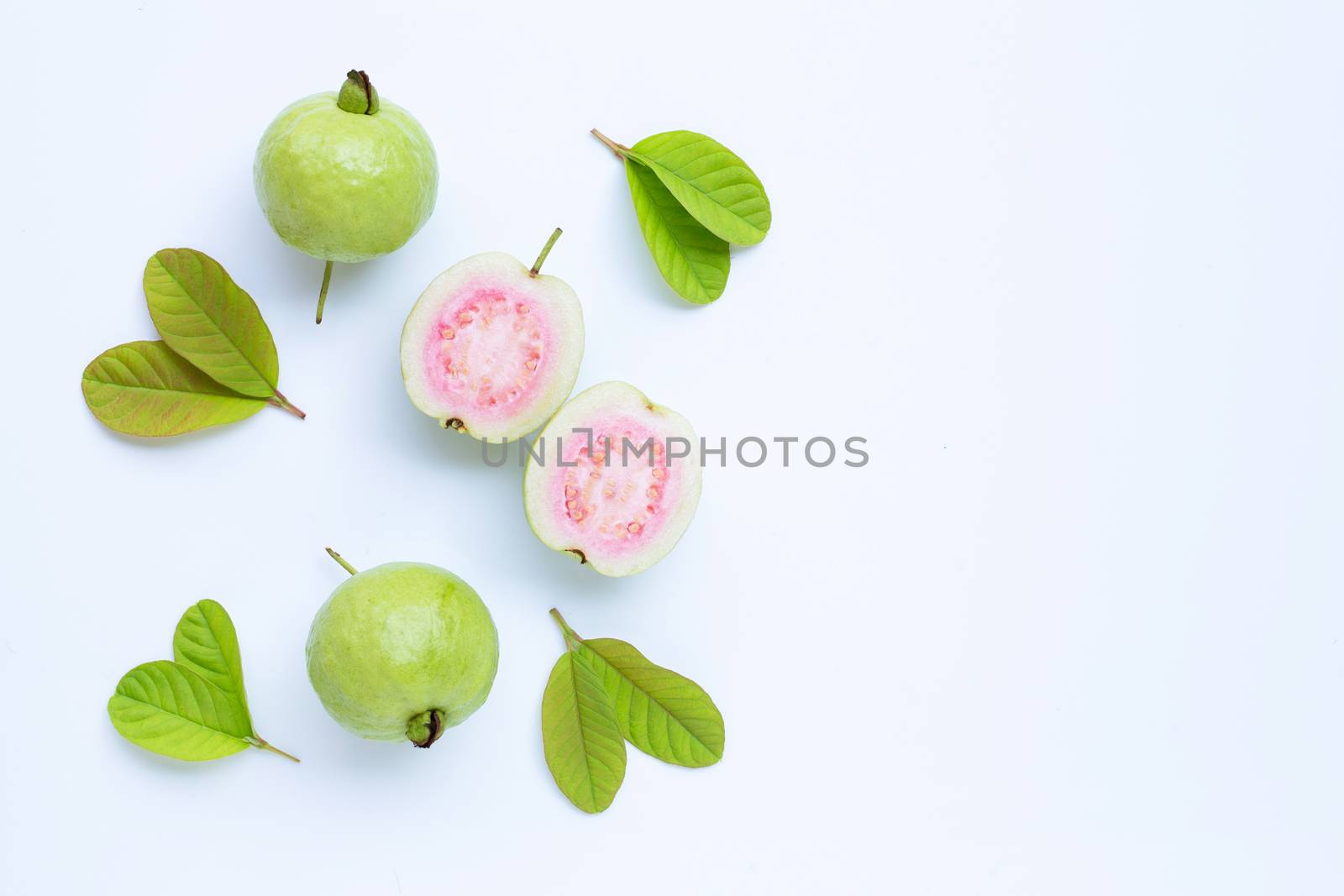 Top view of fresh ripe guava and slices with leaves.