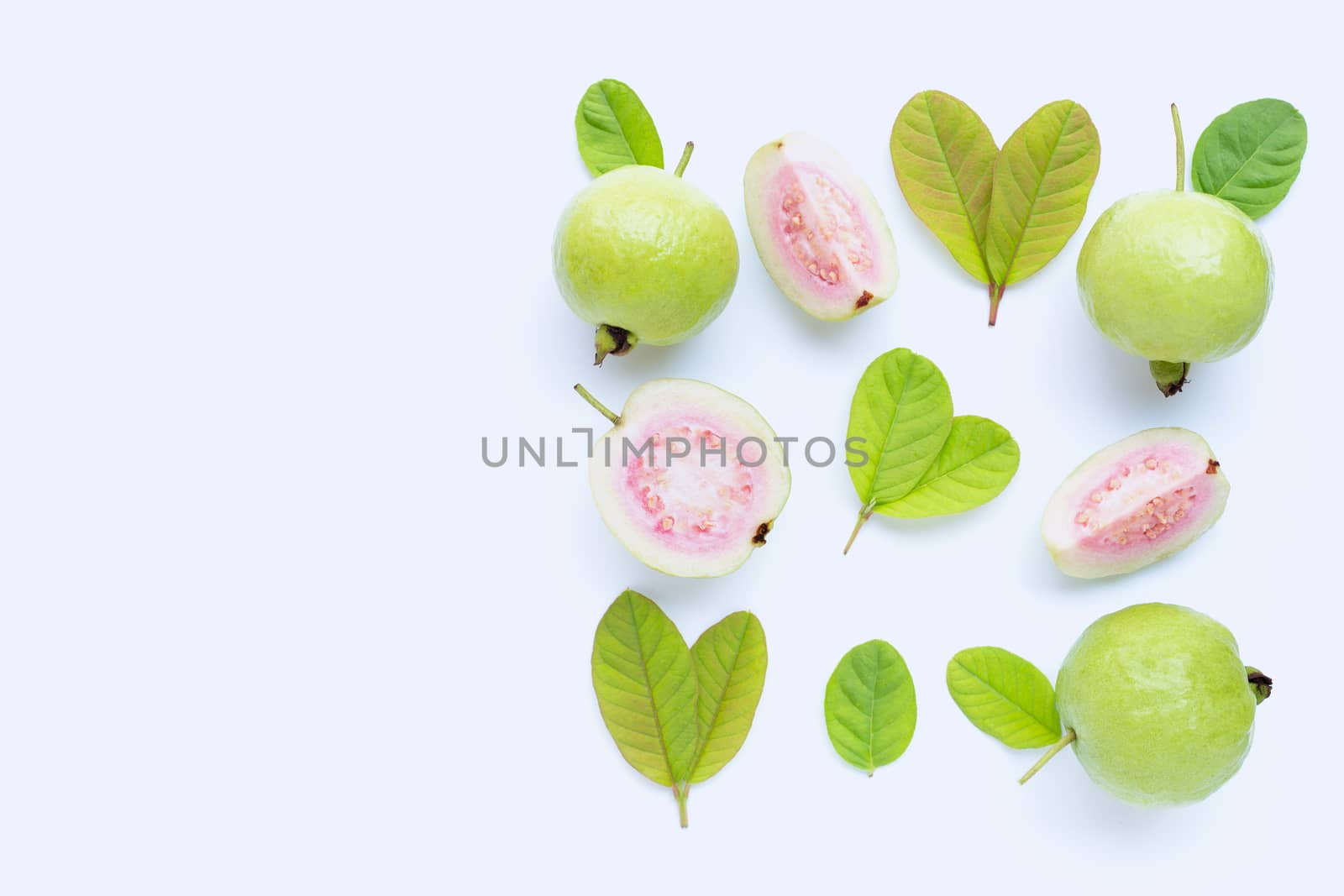 Top view of fresh ripe guava and slices with leaves on white background. Copy space