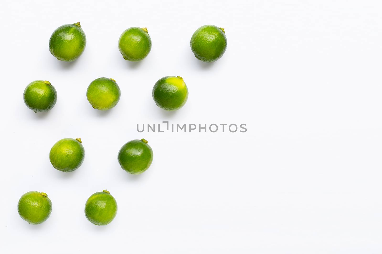 Limes isolated on white background. Top view
