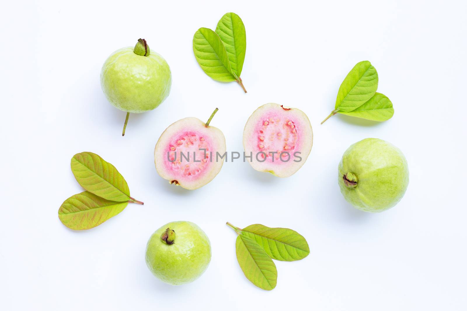 Top view of fresh ripe guava and slices with leaves.