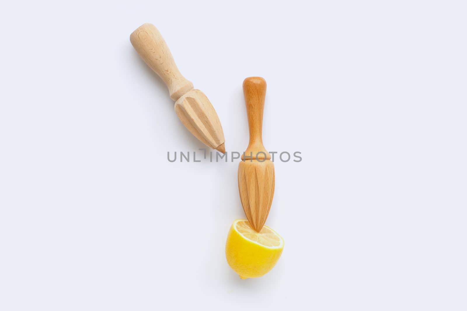 Fresh lemon with two wooden juicer on white background.  Copy space