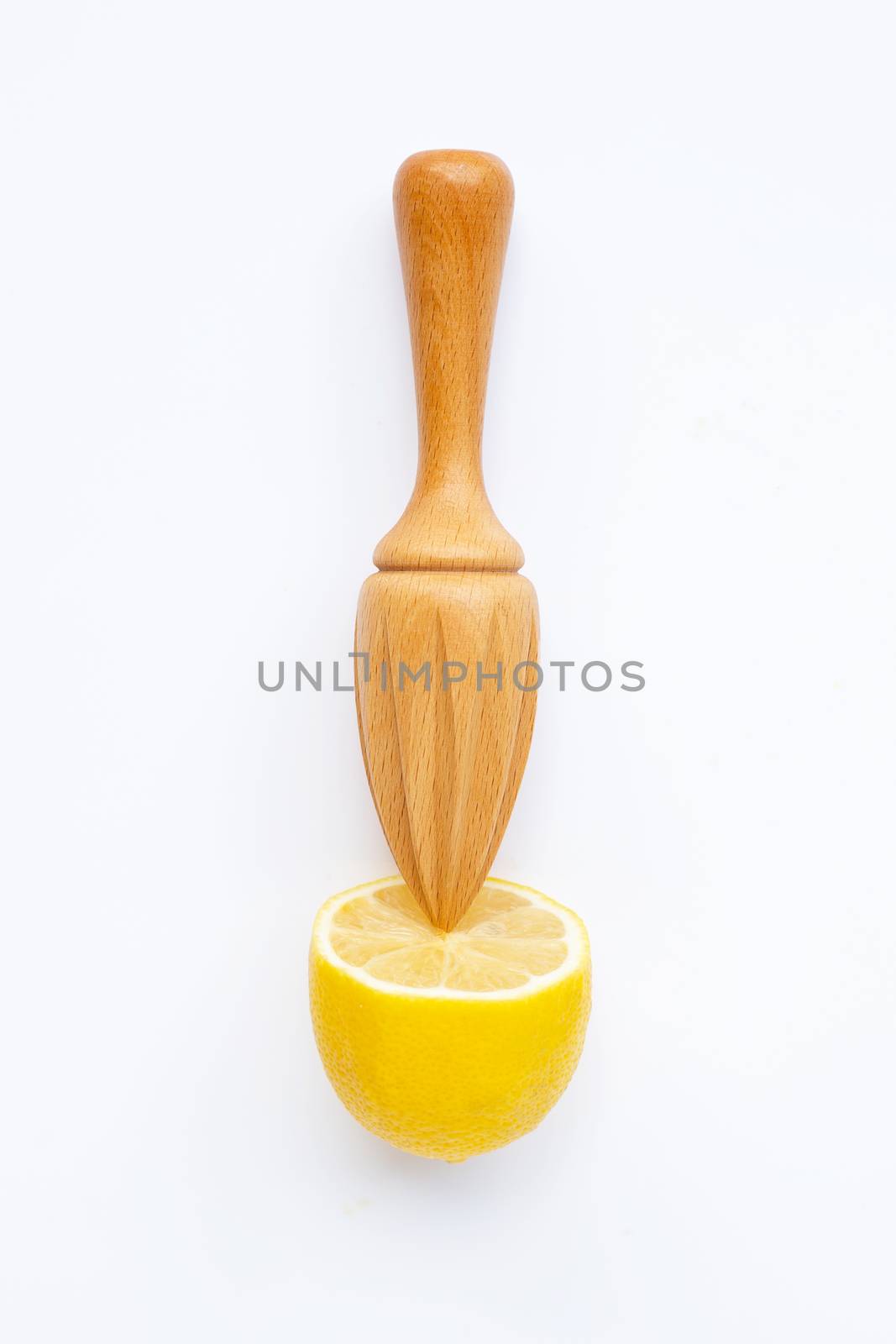 Fresh lemon with wooden juicer on white background. Top view