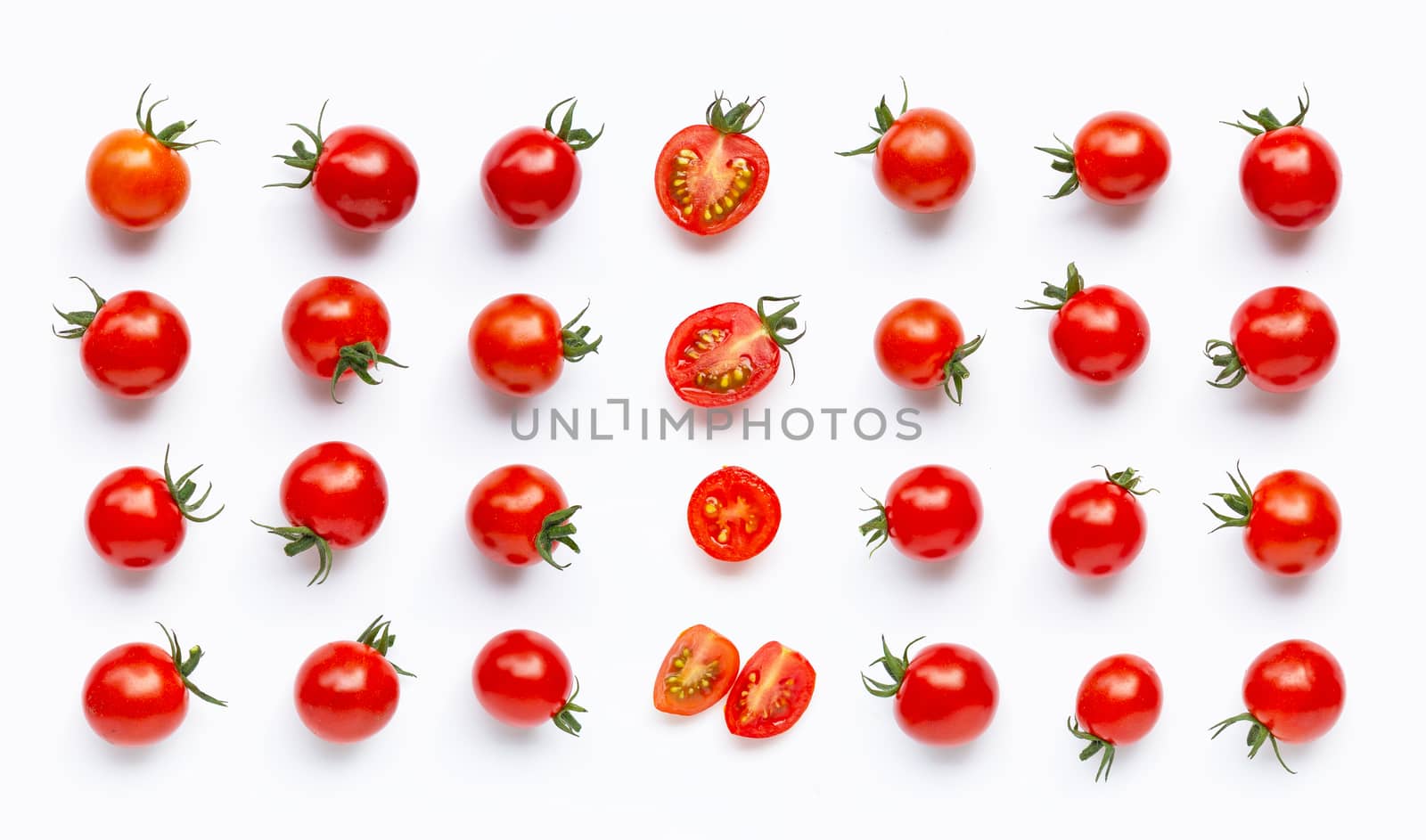 Fresh tomatoes, whole and half cut isolated on white background. Top view