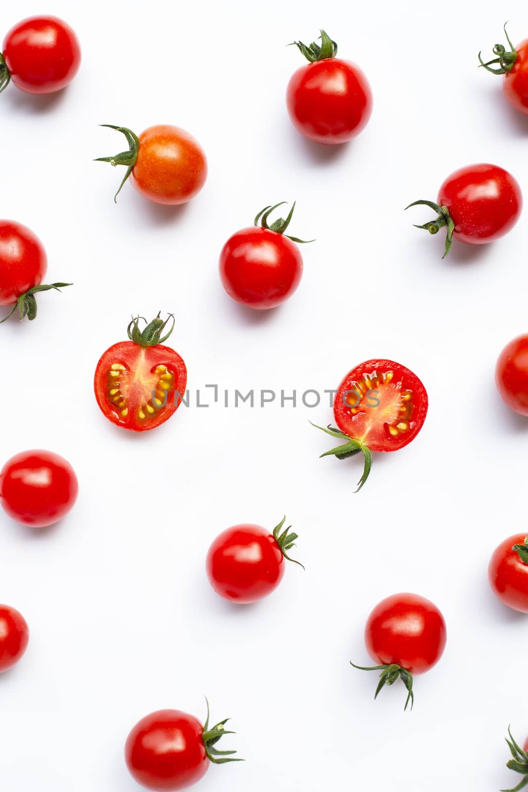 Fresh tomatoes, whole and half cut isolated on white background. Top view