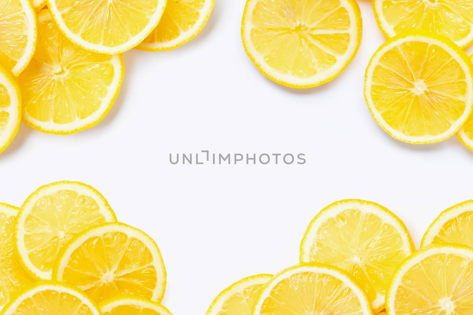 Frame made of fresh lemon with slices on white background. Copy space