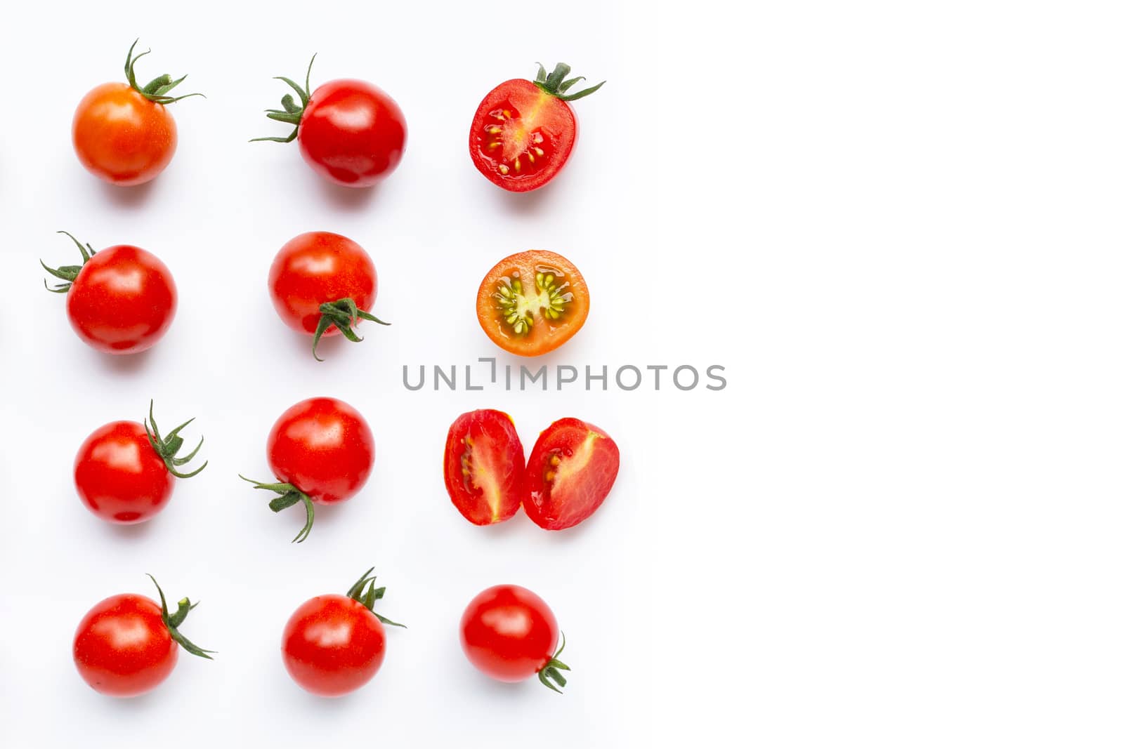Fresh tomatoes, whole and half cut isolated on white background. Top view