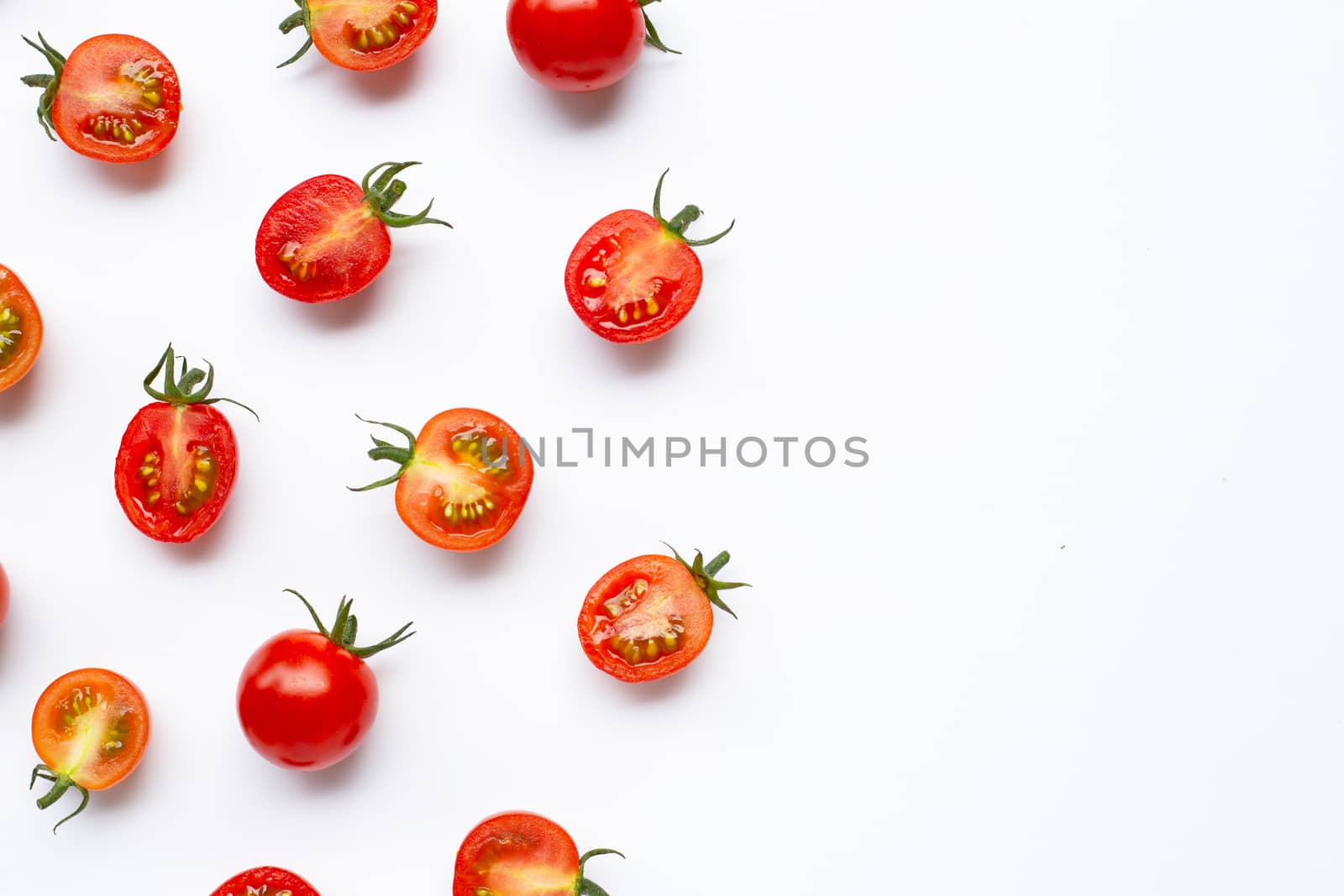 Fresh tomatoes, whole and half cut isolated on white background. Top view