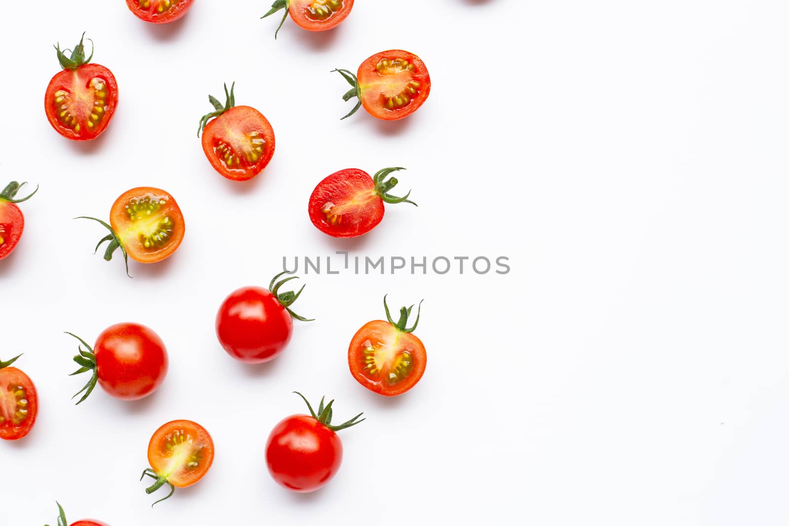 Fresh tomatoes, whole and half cut isolated on white background. Top view