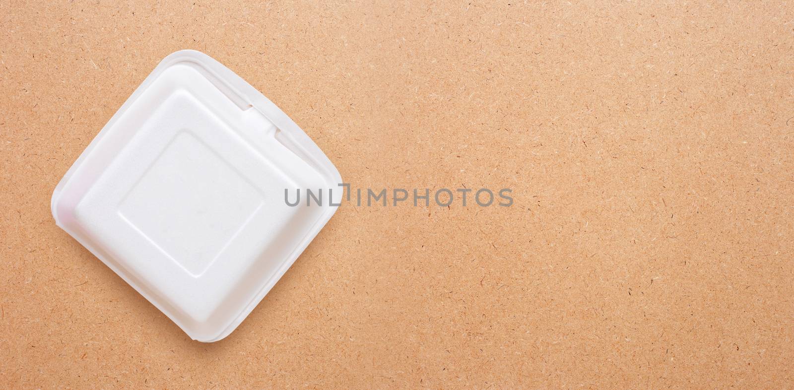 Foam food container on plywood background.  by Bowonpat