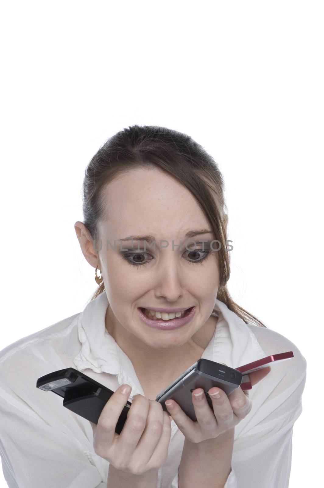 A teenage girl confused by 3 cell phones