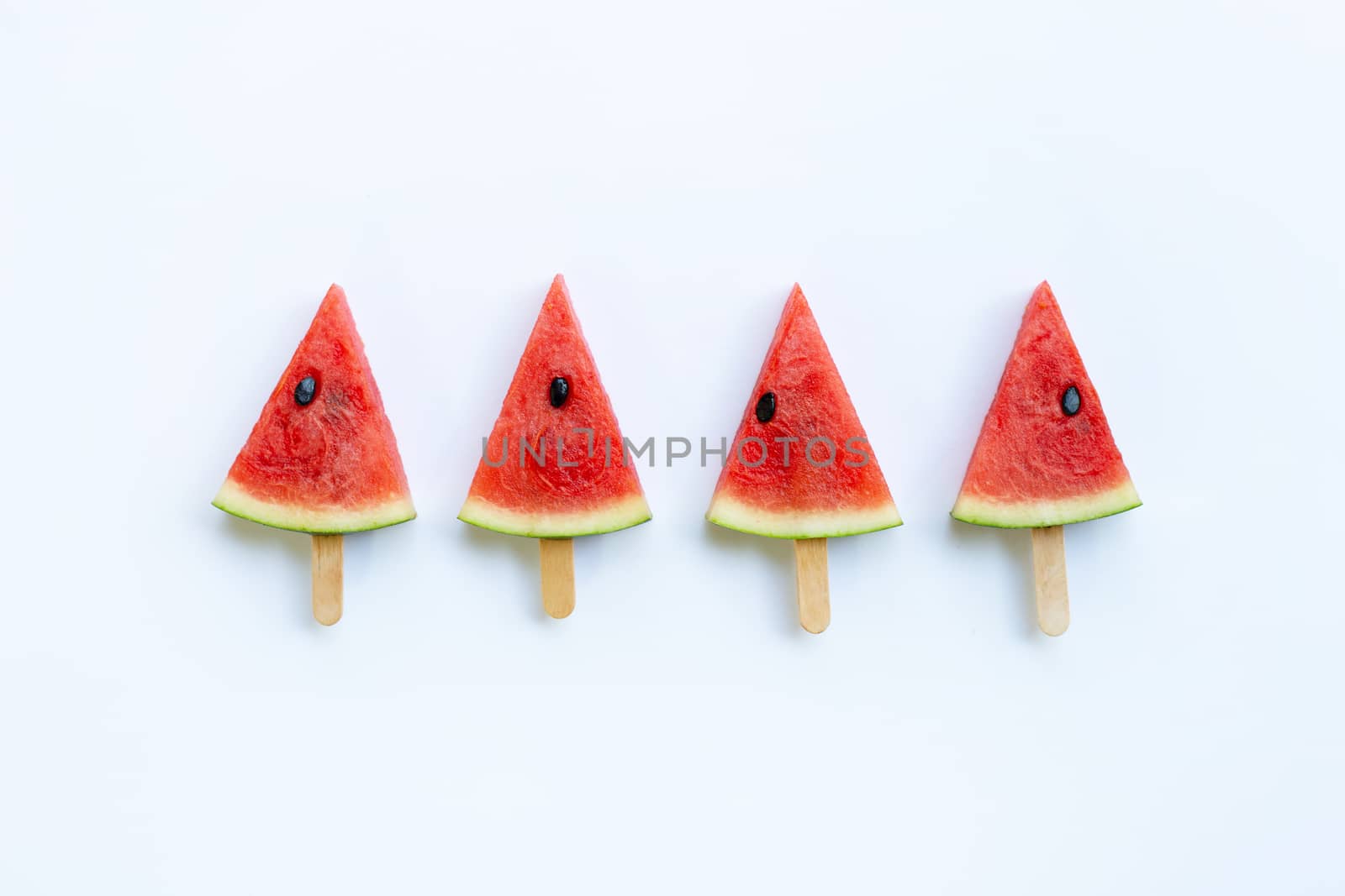 Sweet watermelon slice popsicles on white background