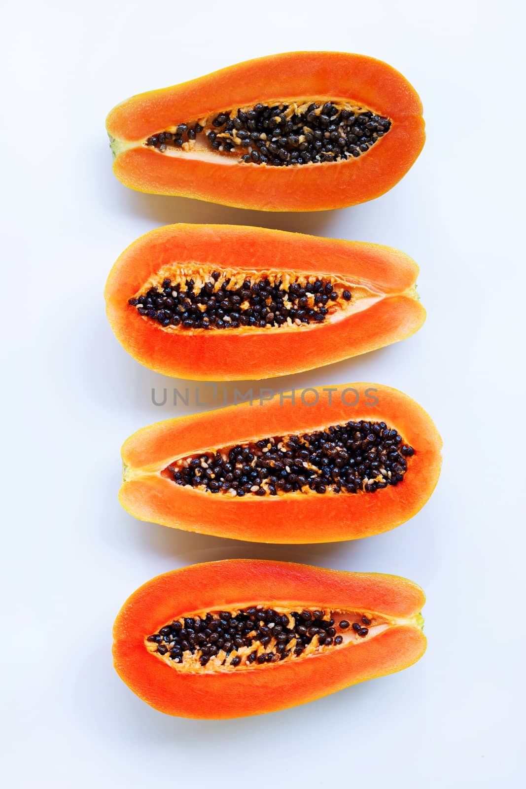 Half of ripe papaya fruit with seeds isolated on white background