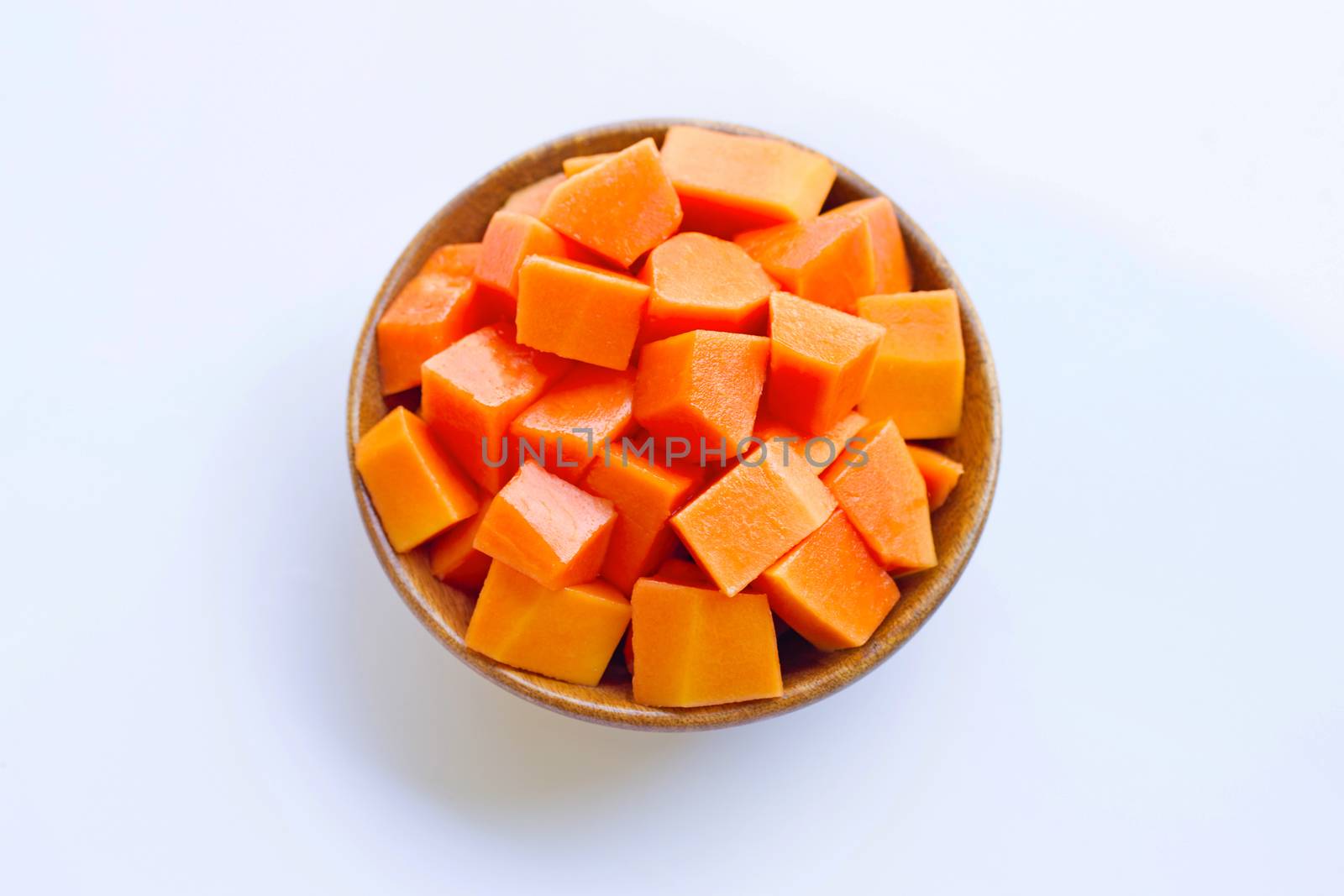 Papaya in wooden bowl on white background