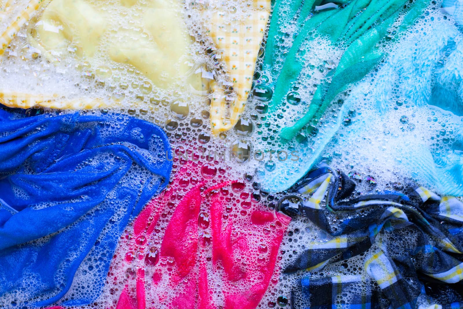 Washing clothes, colorful clothes soaked.