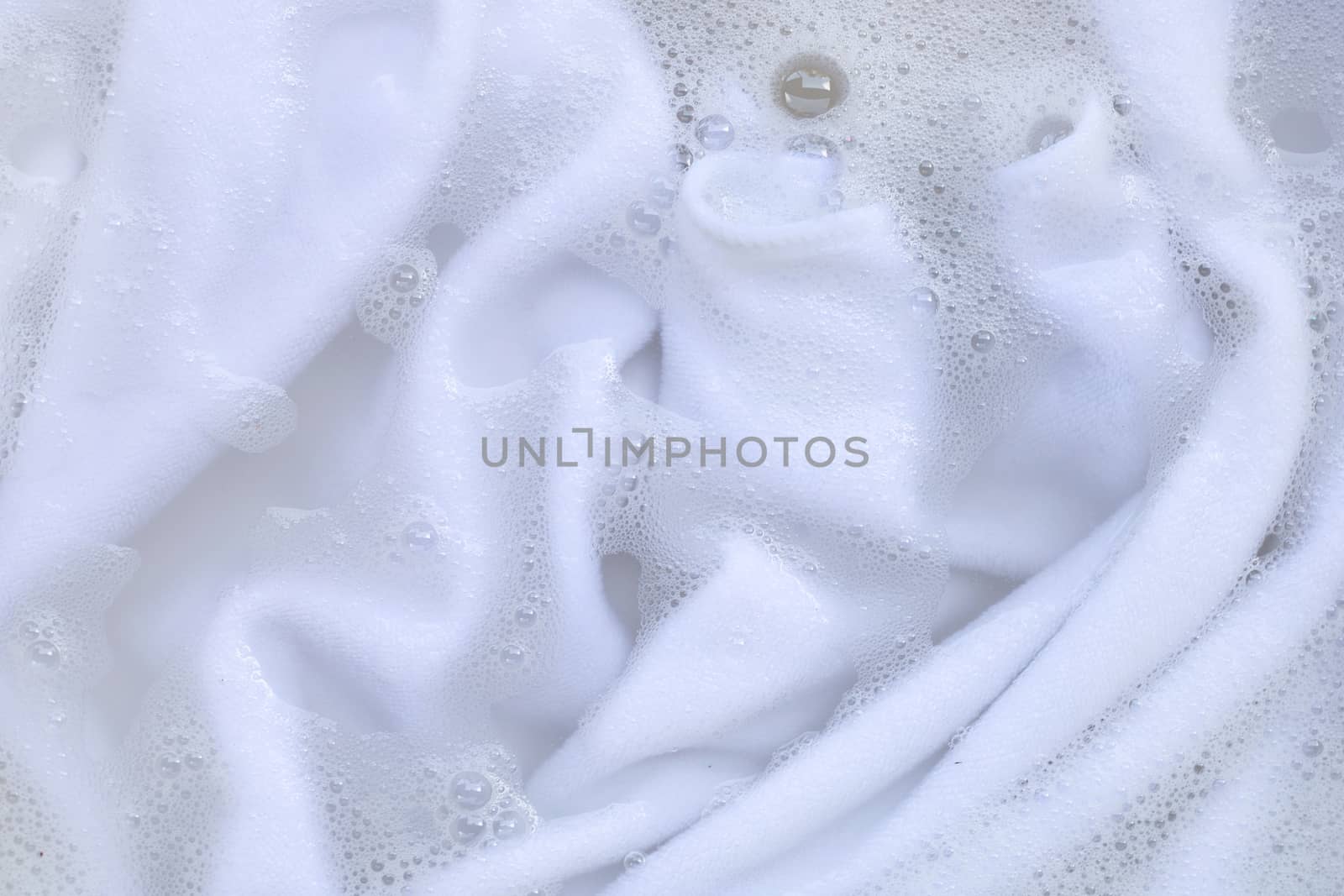 Washing clothes, white clothes soaked.