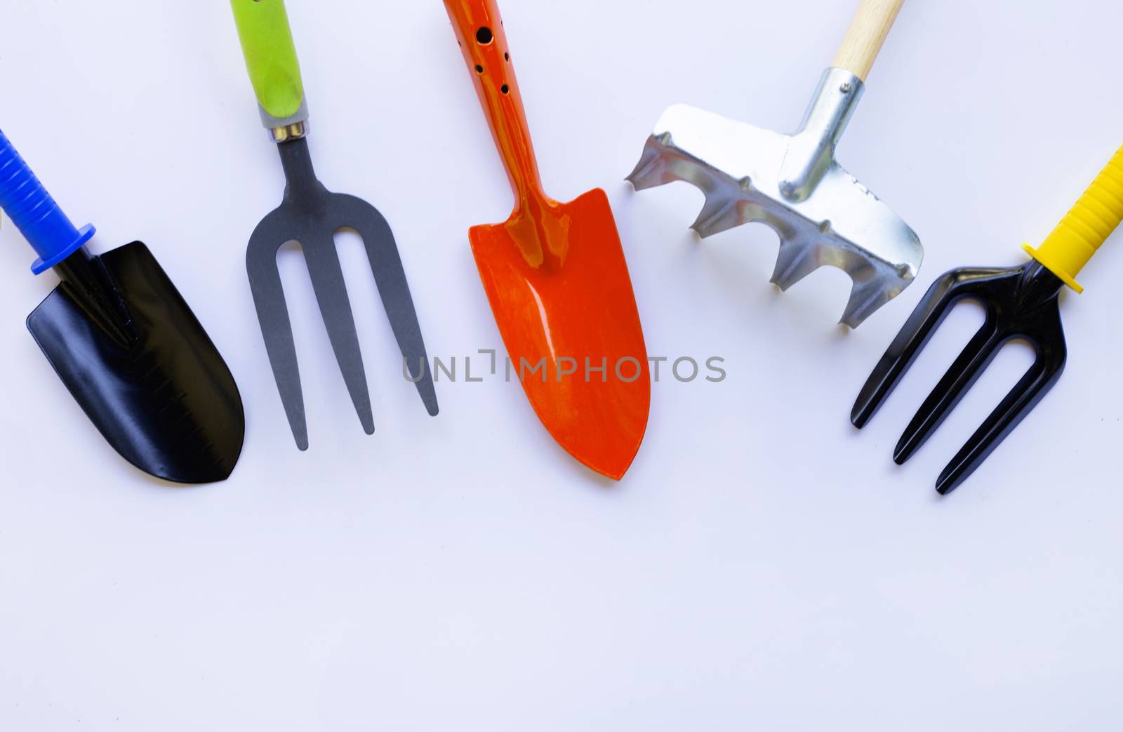 Garden shovel and fork with rake solated on white background.