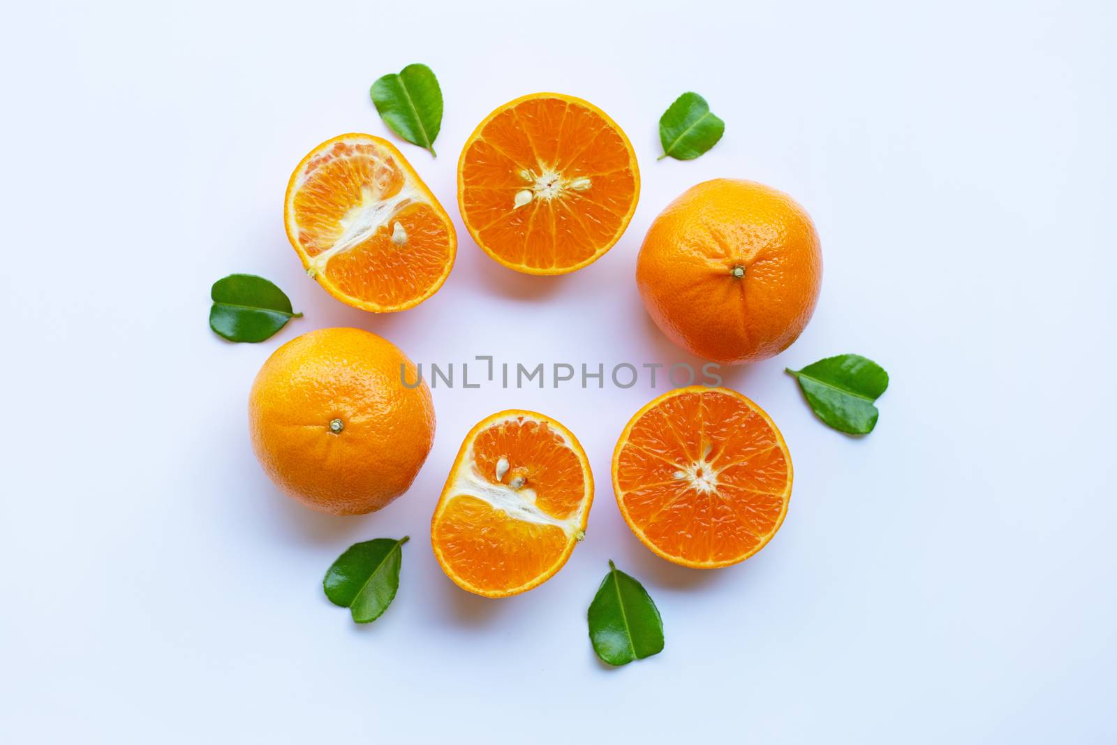Fresh oranges with half of Bergamot kaffir lime leaves, heart shape on white background
