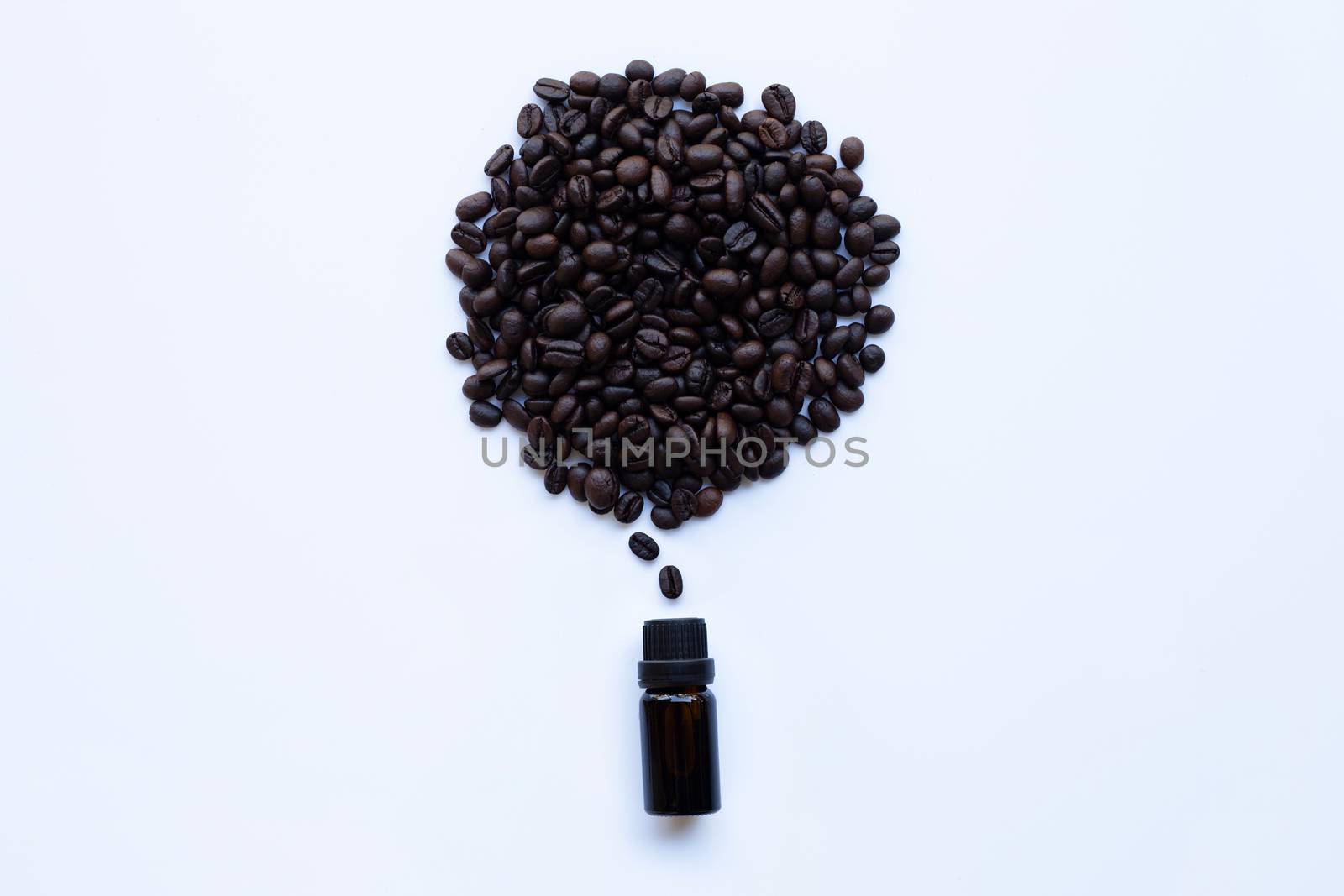 Glass bottle with essential oil of coffee and Coffee grains on white background