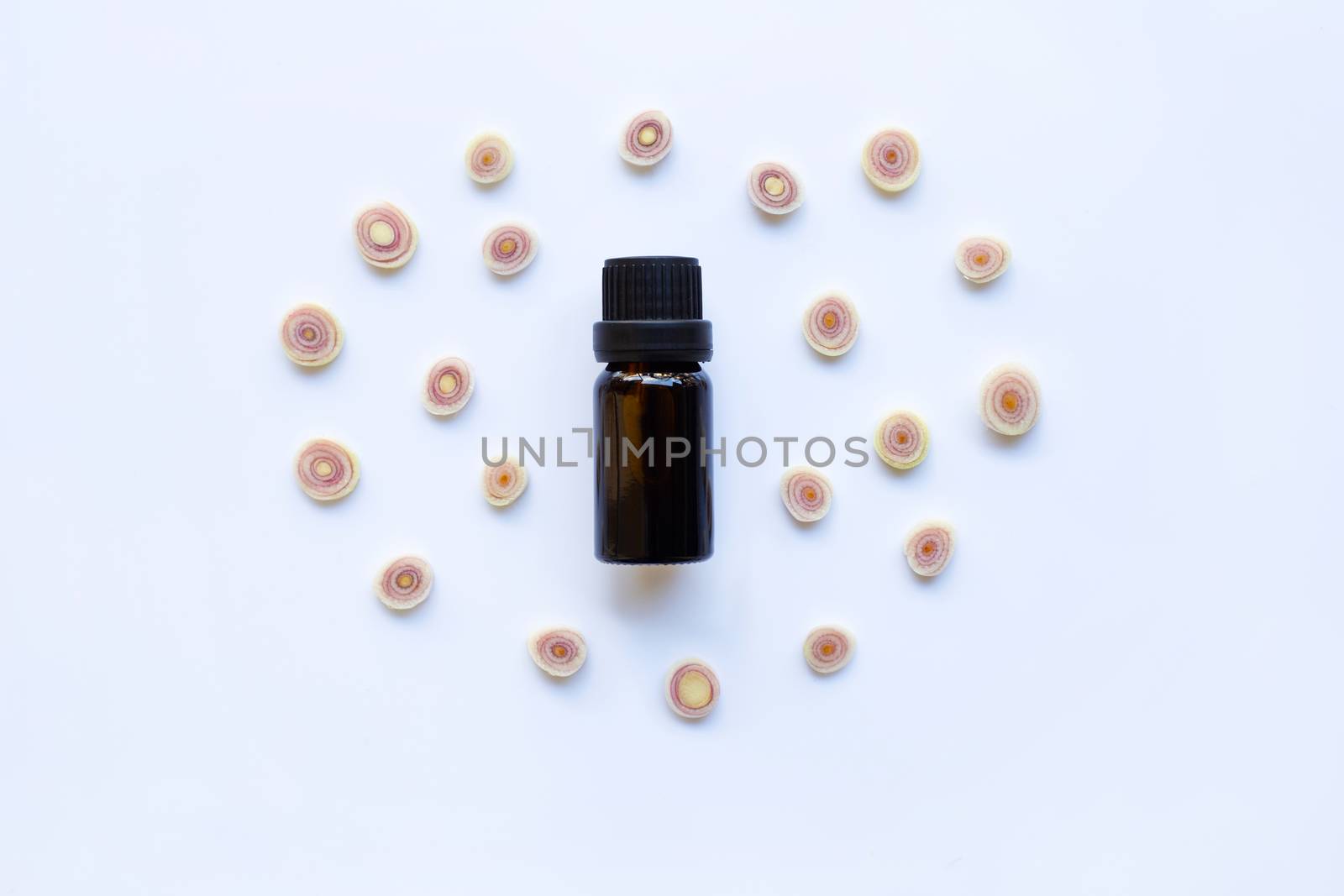 Lemon grass essential oil with  sliced fresh Lemon grass on white background