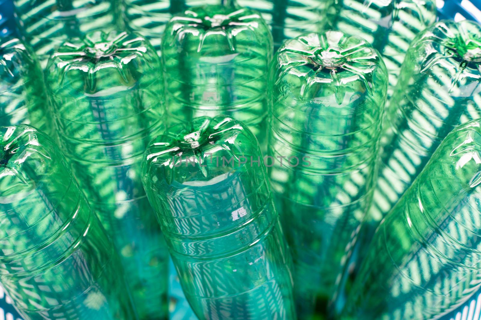 Plastic bottles in blue waste basket.