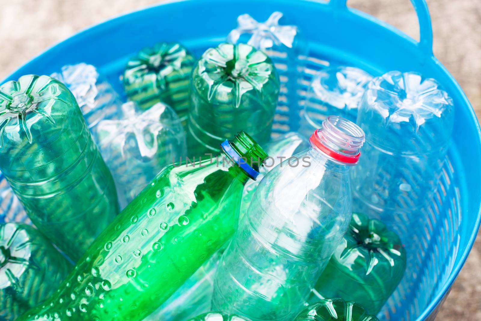 Plastic bottles in blue waste basket.