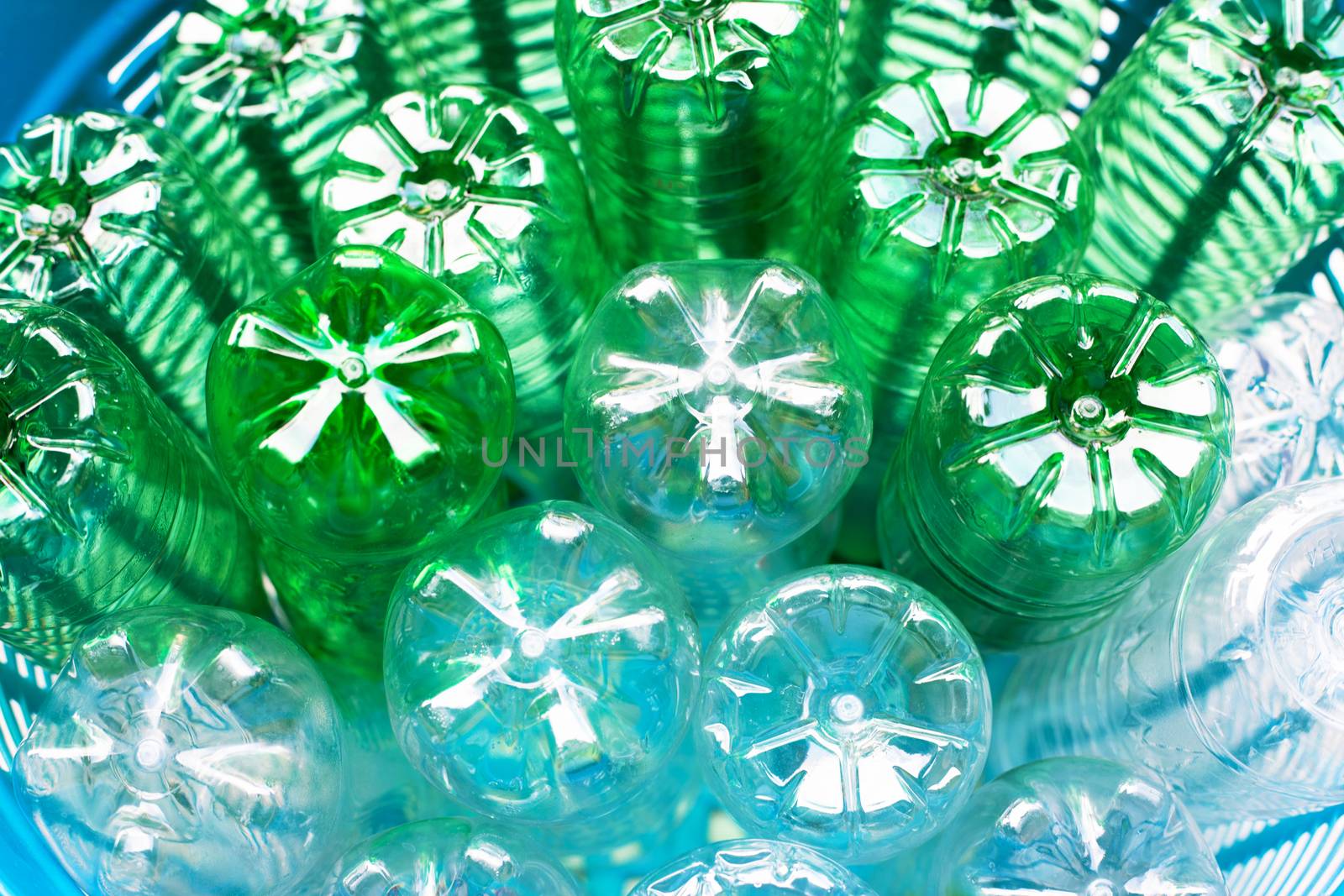 Plastic bottles in blue waste basket.