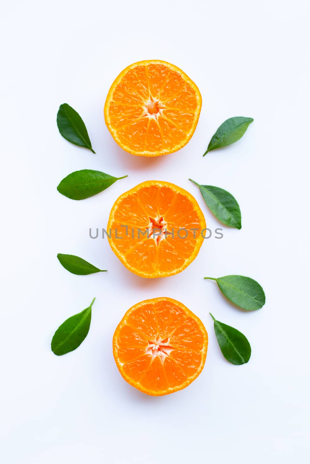 Fresh orange citrus fruit with green leaves on white. by Bowonpat