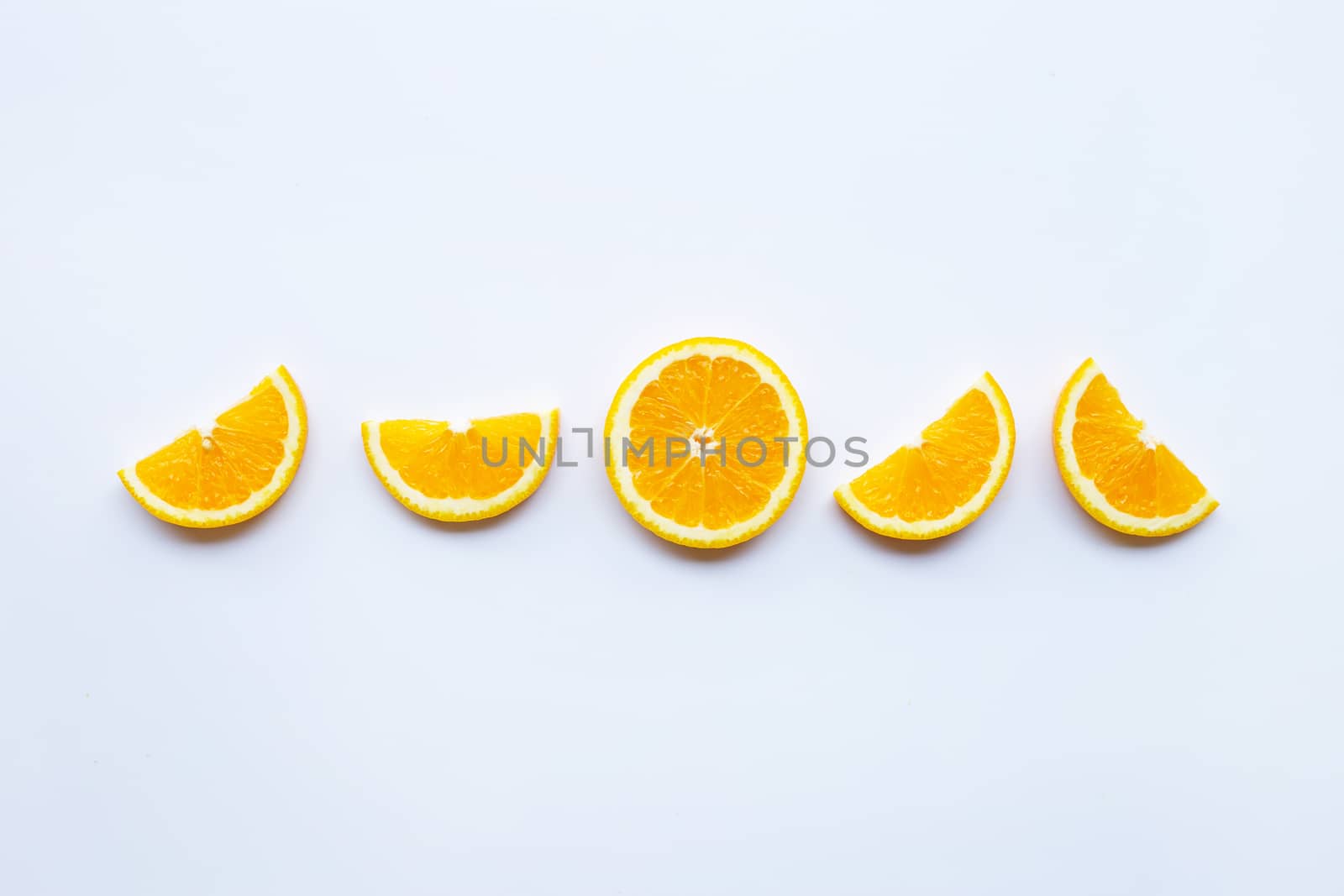 Fresh orange citrus fruit slices on white background.