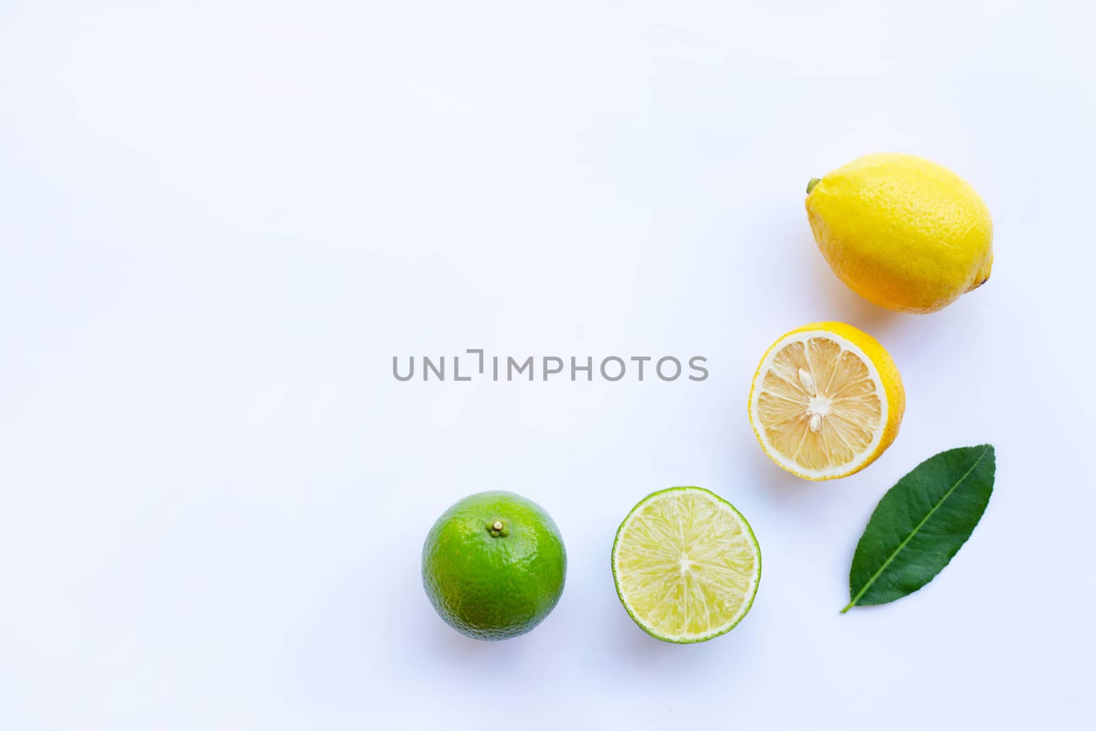 Ripe lemons and limes on white background.