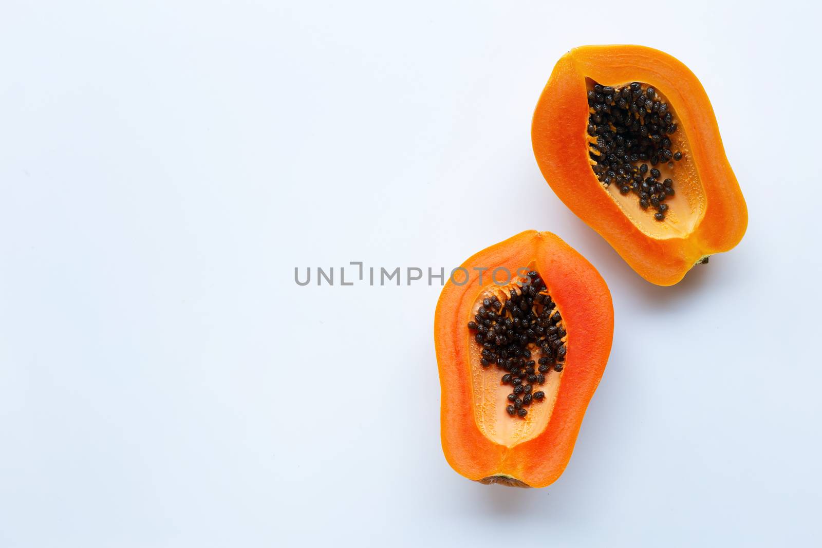 Slices of papaya fruit on a white background. Copy space