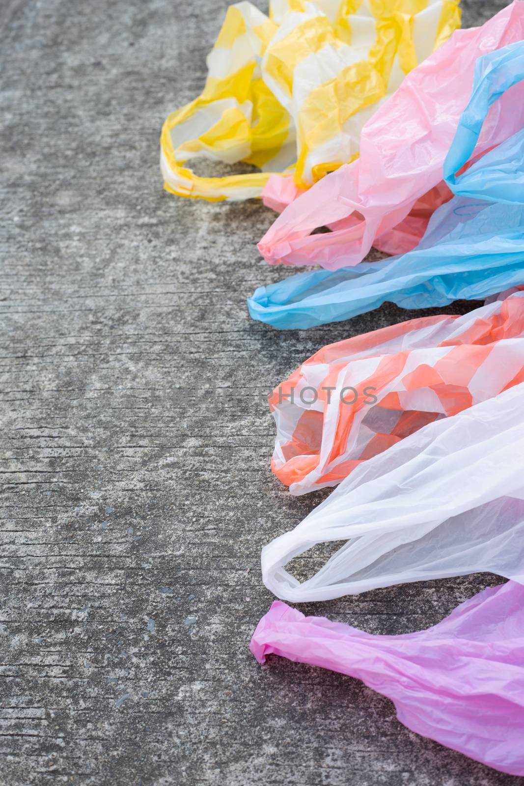 Plastic garbage bags on cement floor by Bowonpat