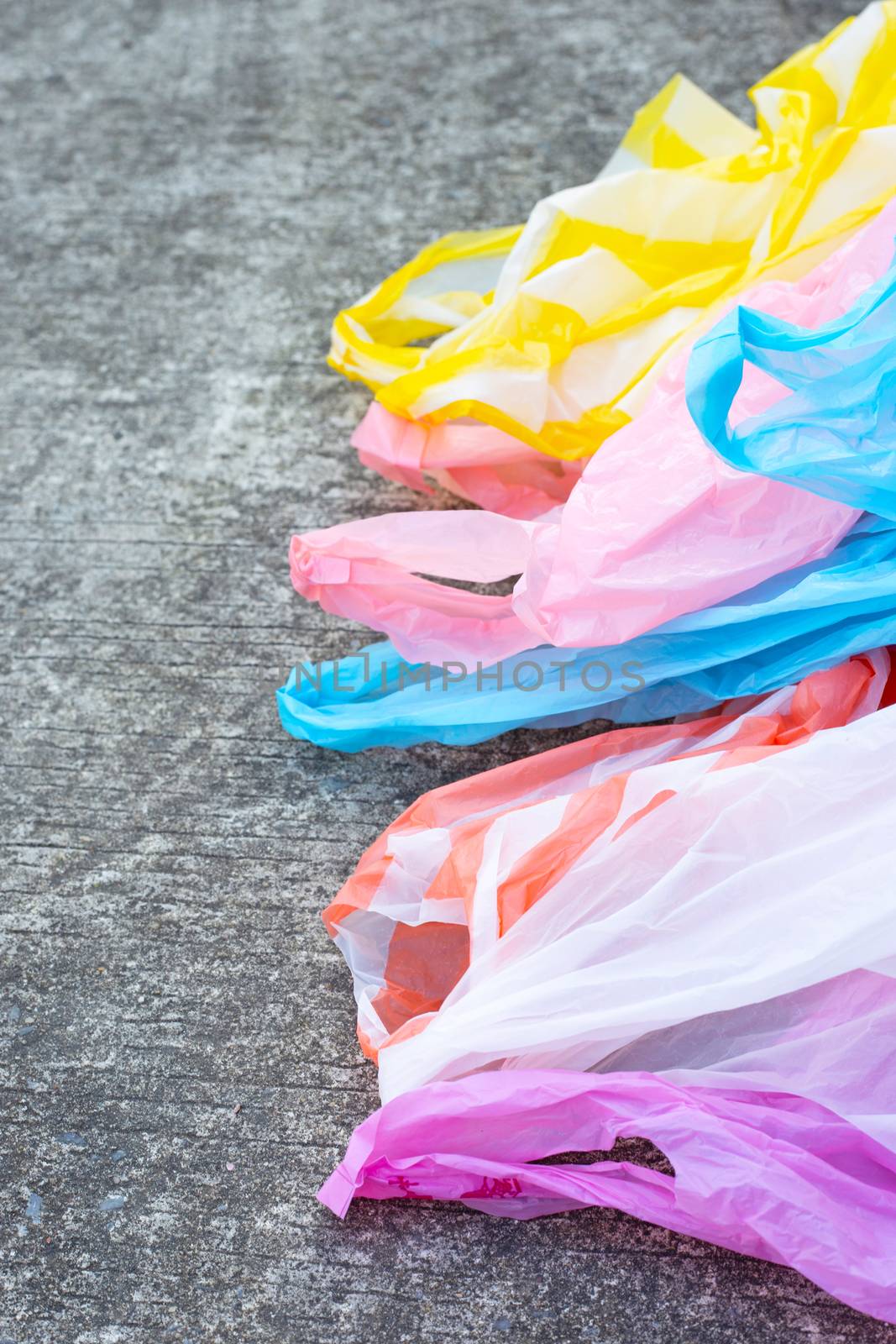 Plastic garbage bags on cement floor  by Bowonpat