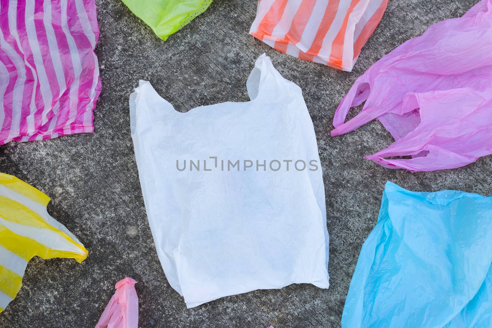 Plastic bags on cement floor background.