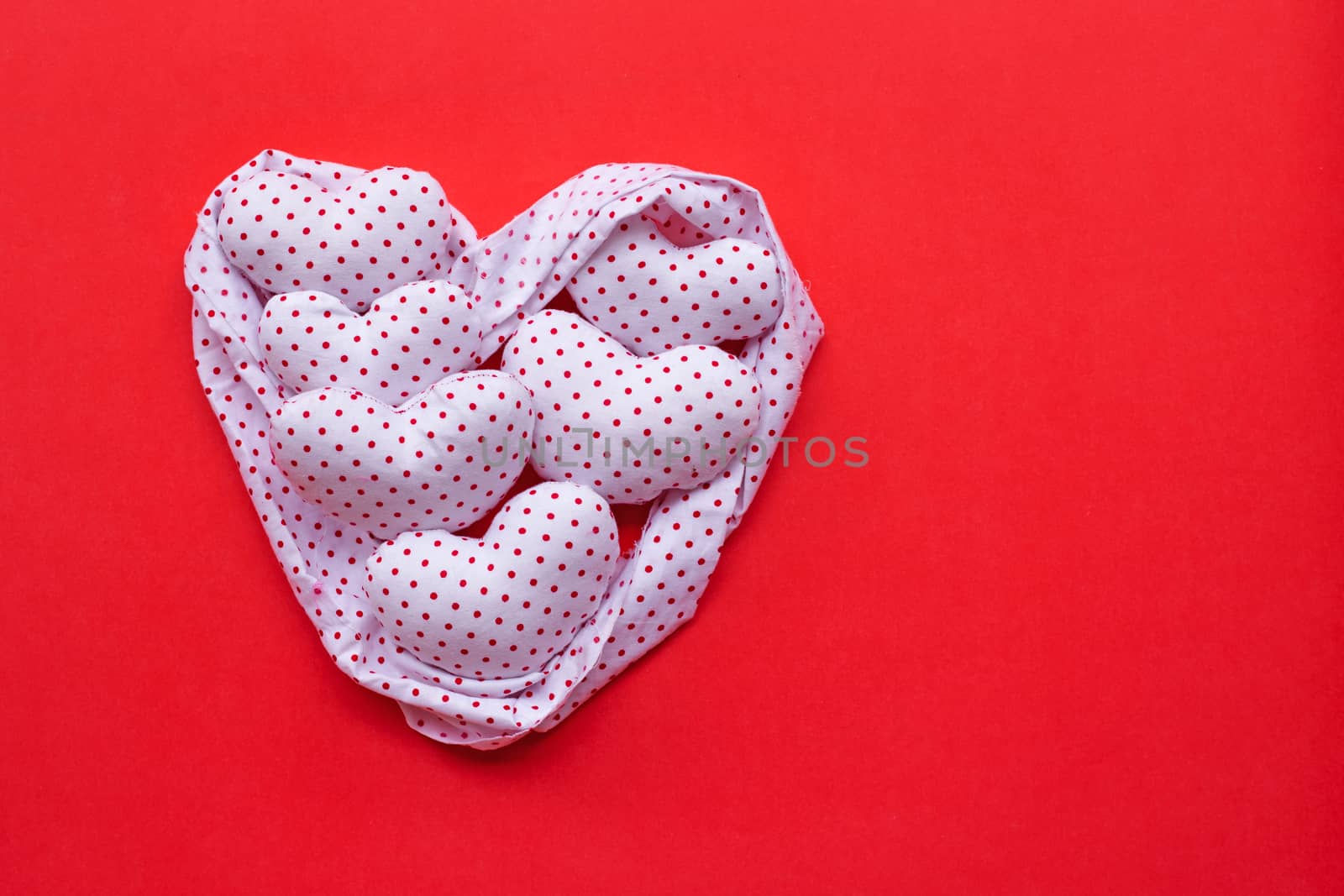 Red dots on white heart shape, Valentine's hearts on red background, Top view with copy space