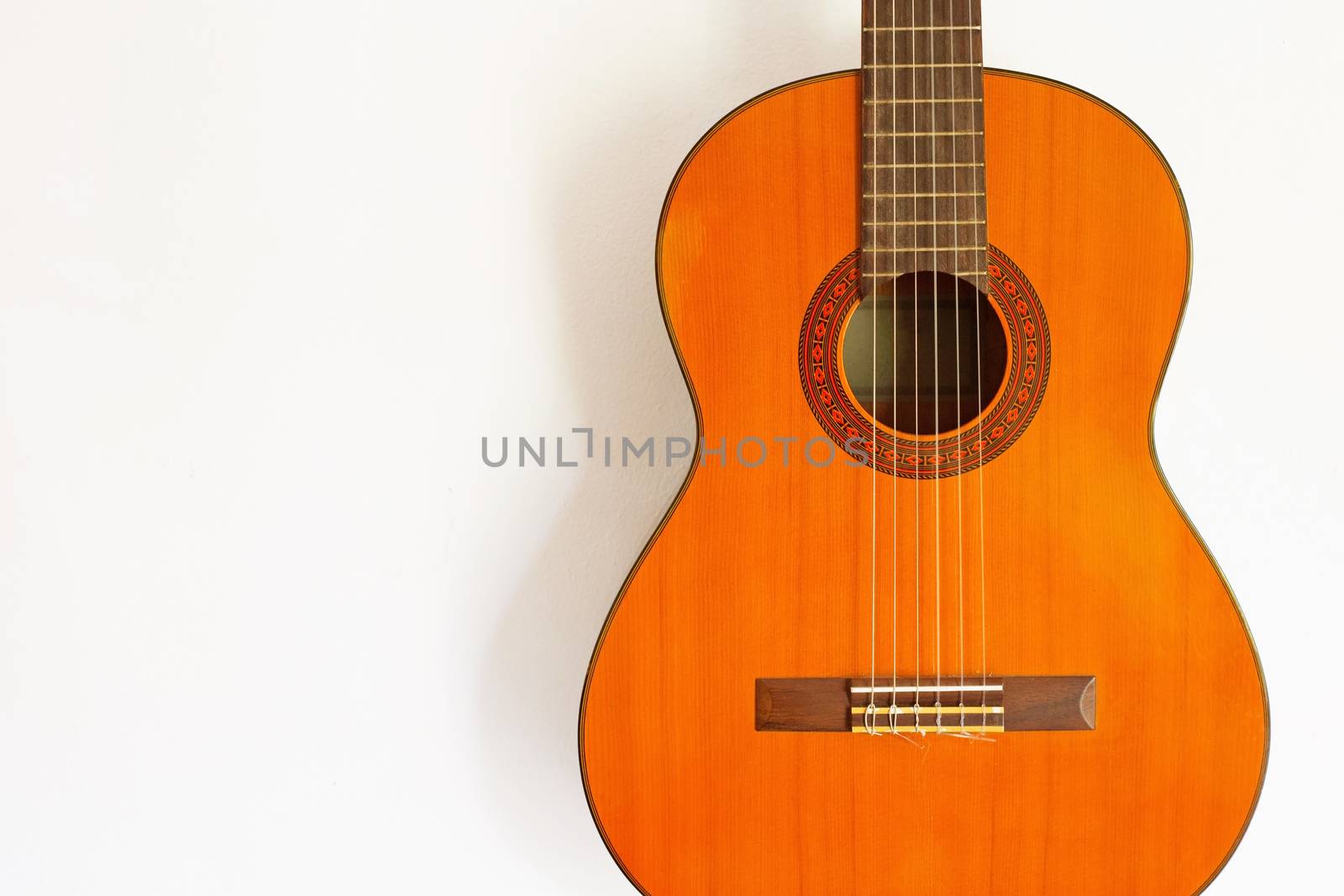 Classic acoustic guitar on white wall