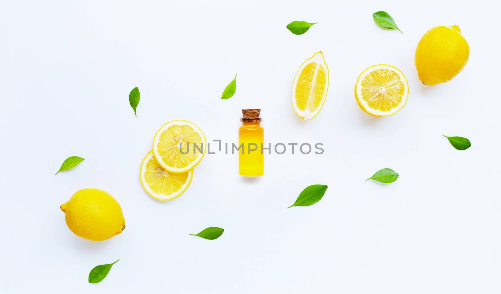 Essential oil with lemon on white background.