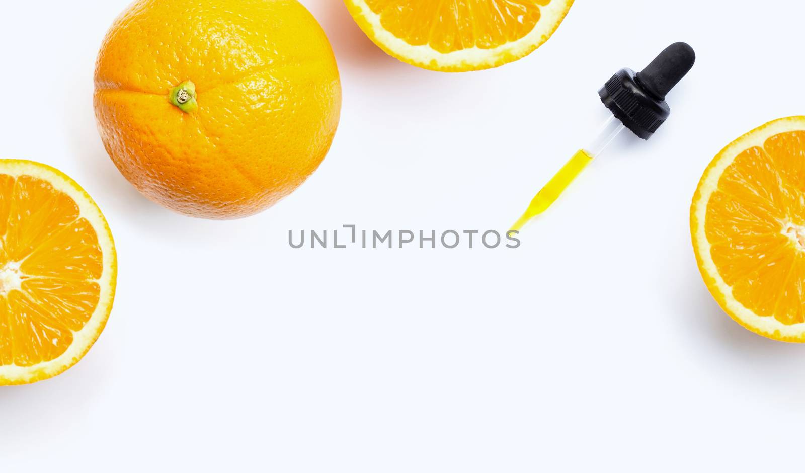 Essential oil with oranges on white background.
