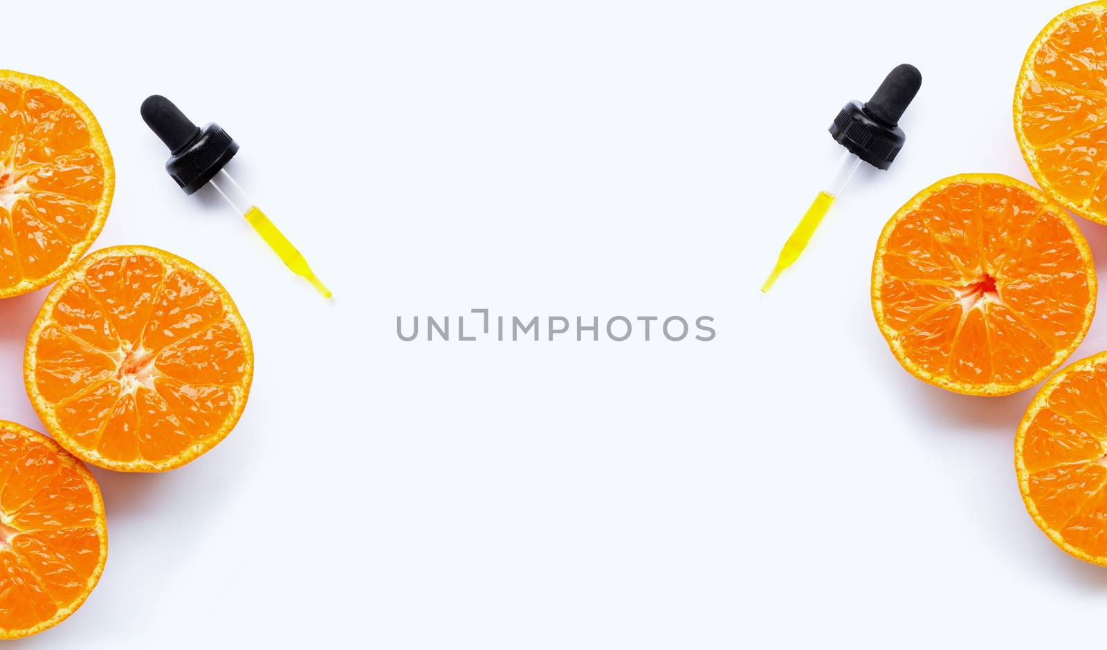 Essential oil with oranges on white background.