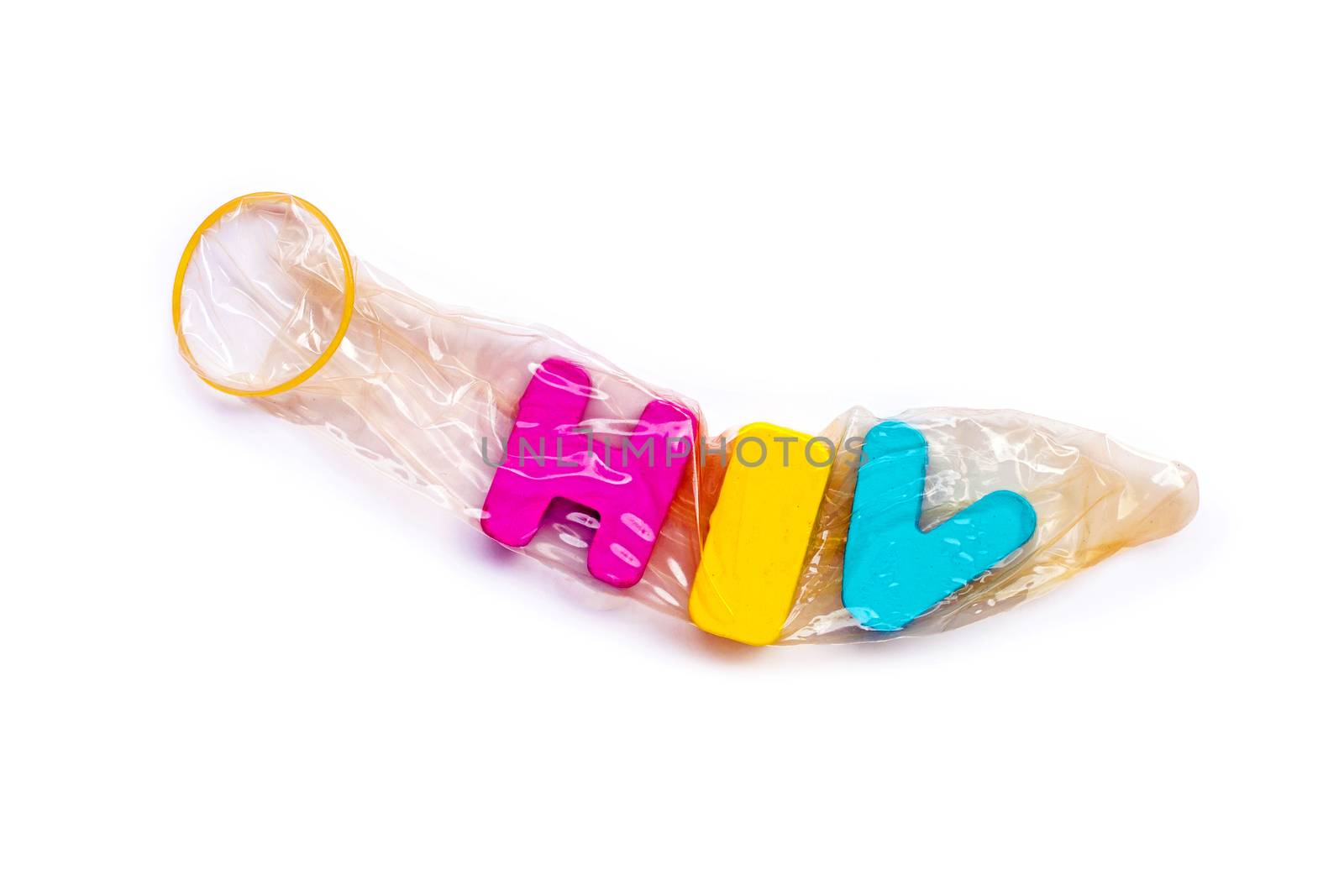 Condom with "HIV" wooden alphabet on white background.
