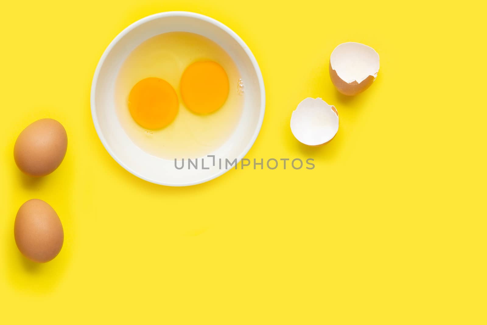 Eggs on yellow background. Top view