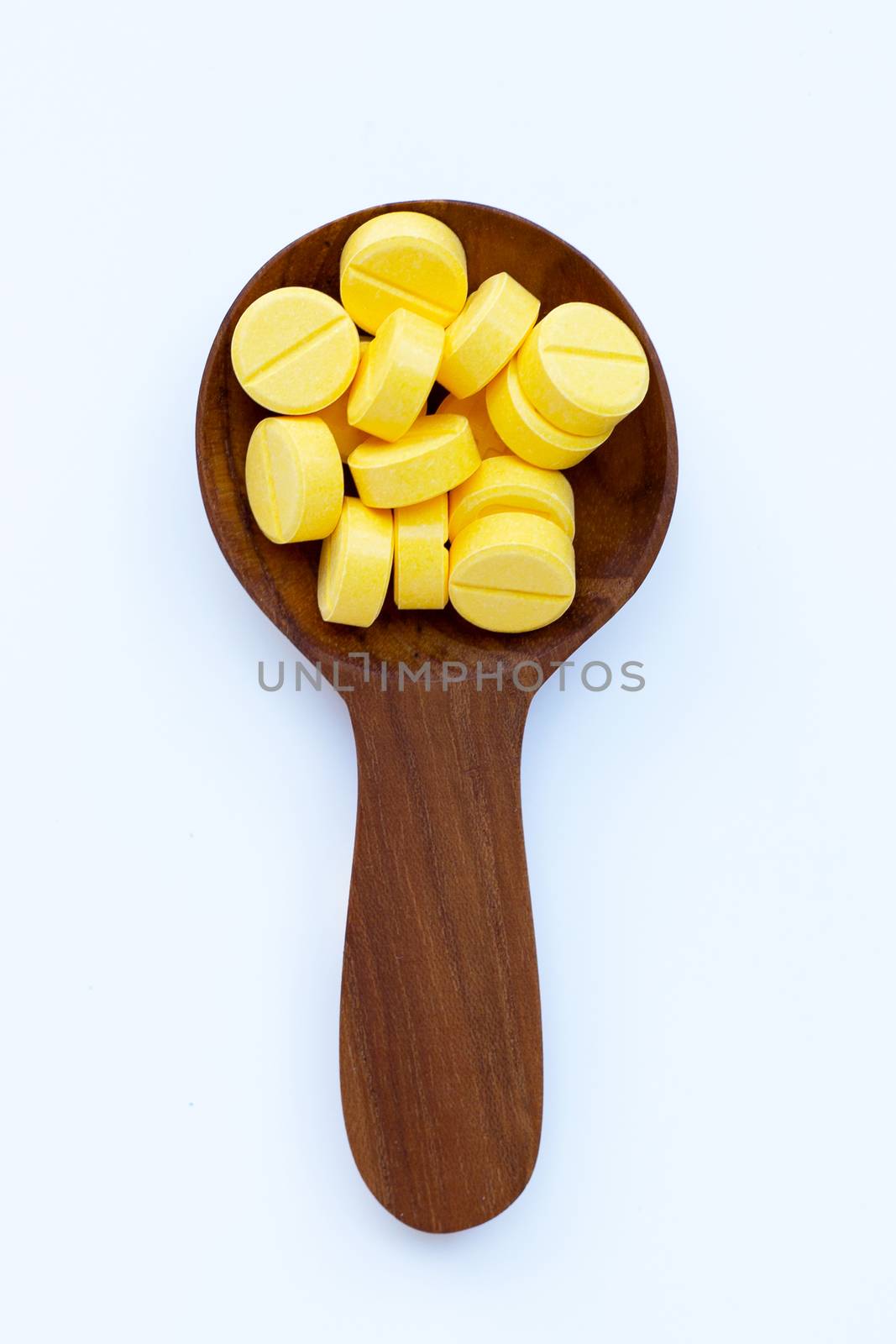 Yellow tablets of Paracetamol on white background.  