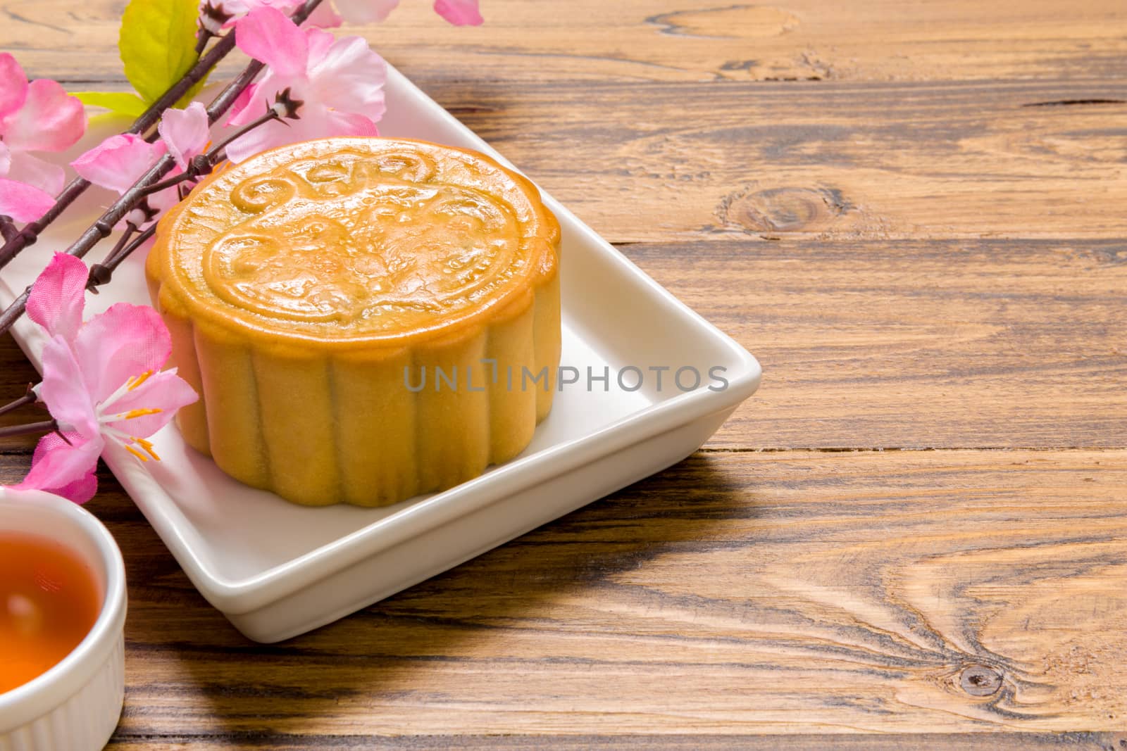 Traditional Chinese mooncake eaten with hot tea for relaxing time.