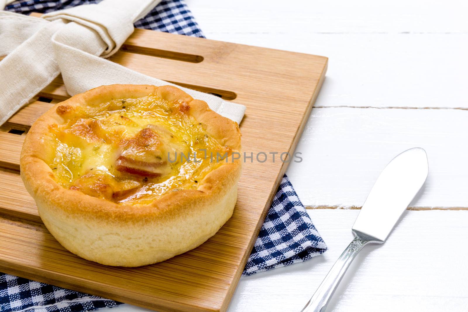 Fresh chesses bread with coffee cup on white wooden background.