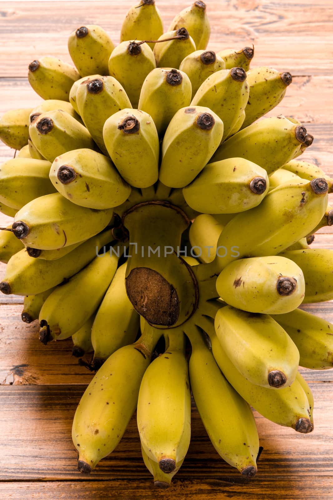 Bunch of ripe banana on wooden background.