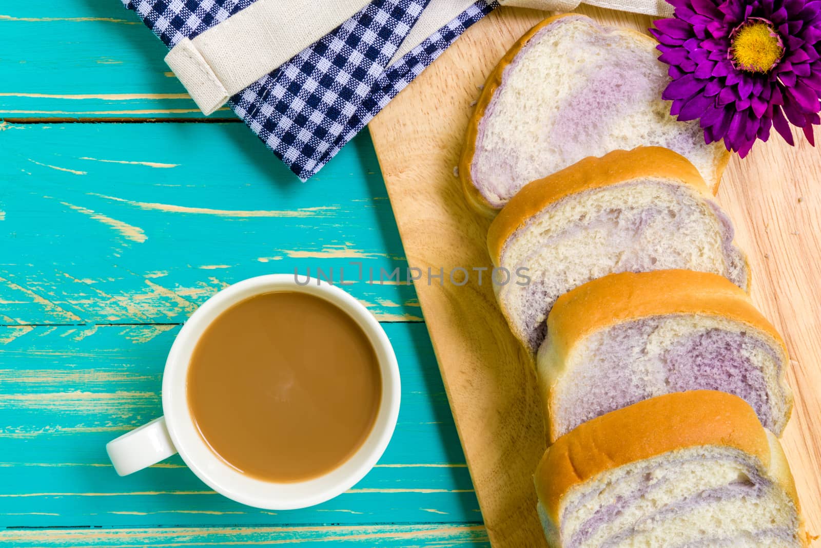 Taro bread with coffee for breakfast on vintage wooden background.