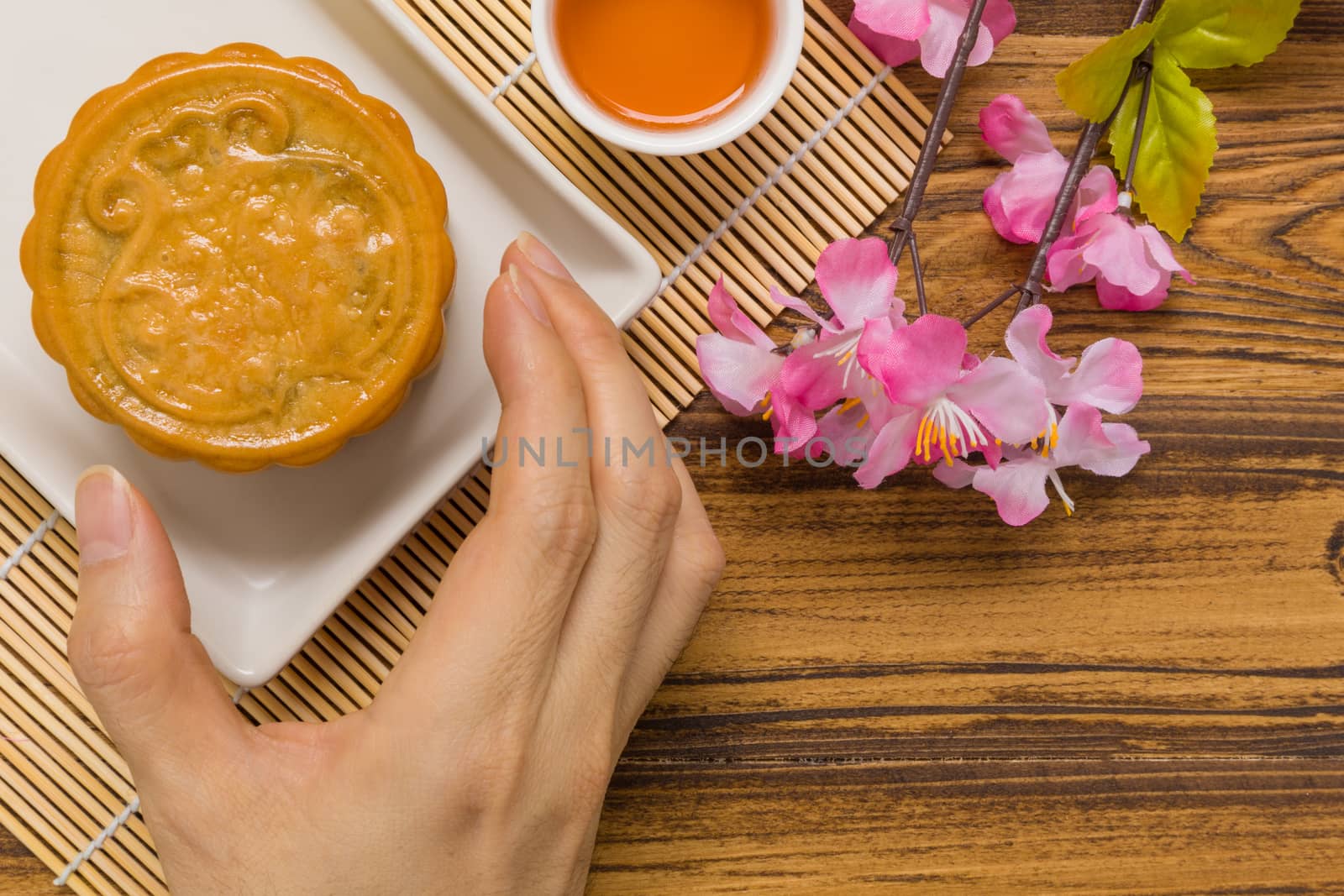 Traditional Chinese mooncake eaten with hot tea for relaxing time.