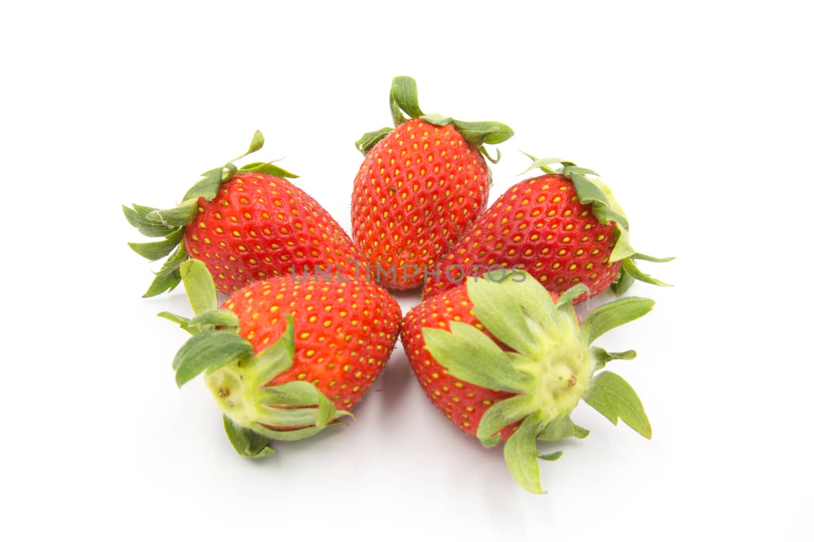 Five strawberries placed on a white background.