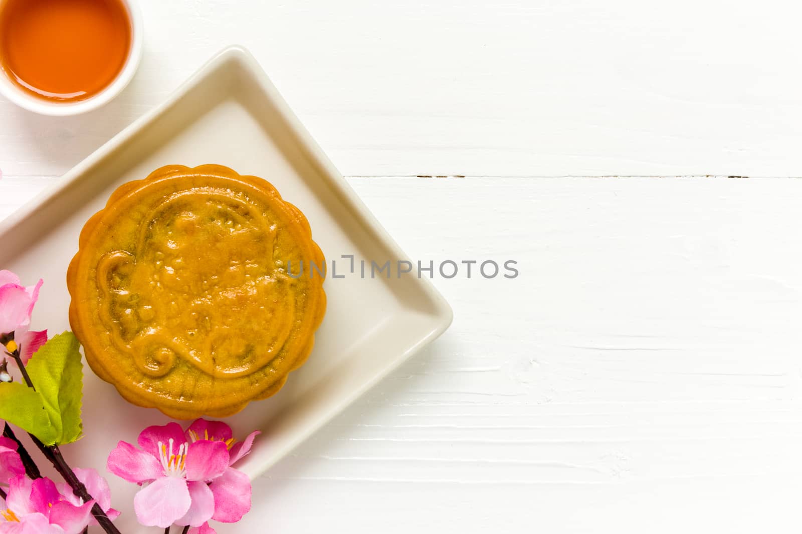 Traditional Chinese mooncake eaten with hot tea for relaxing time.