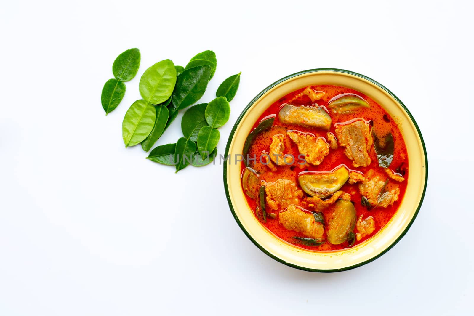 Red curry round eggplant with pork, white background. Copy space