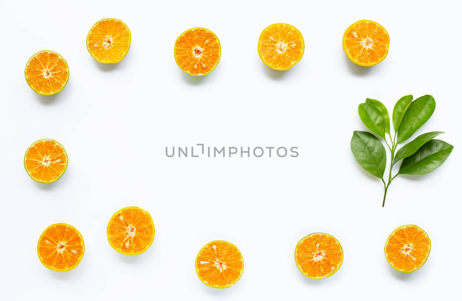 Frame made of fresh orange on white background.